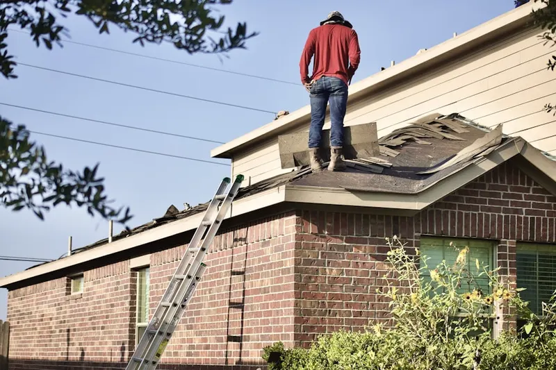 Professional roofer working on a residential roof in Lagro